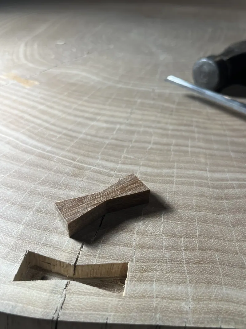 Butterfly joint inlaid across a crack in a slab