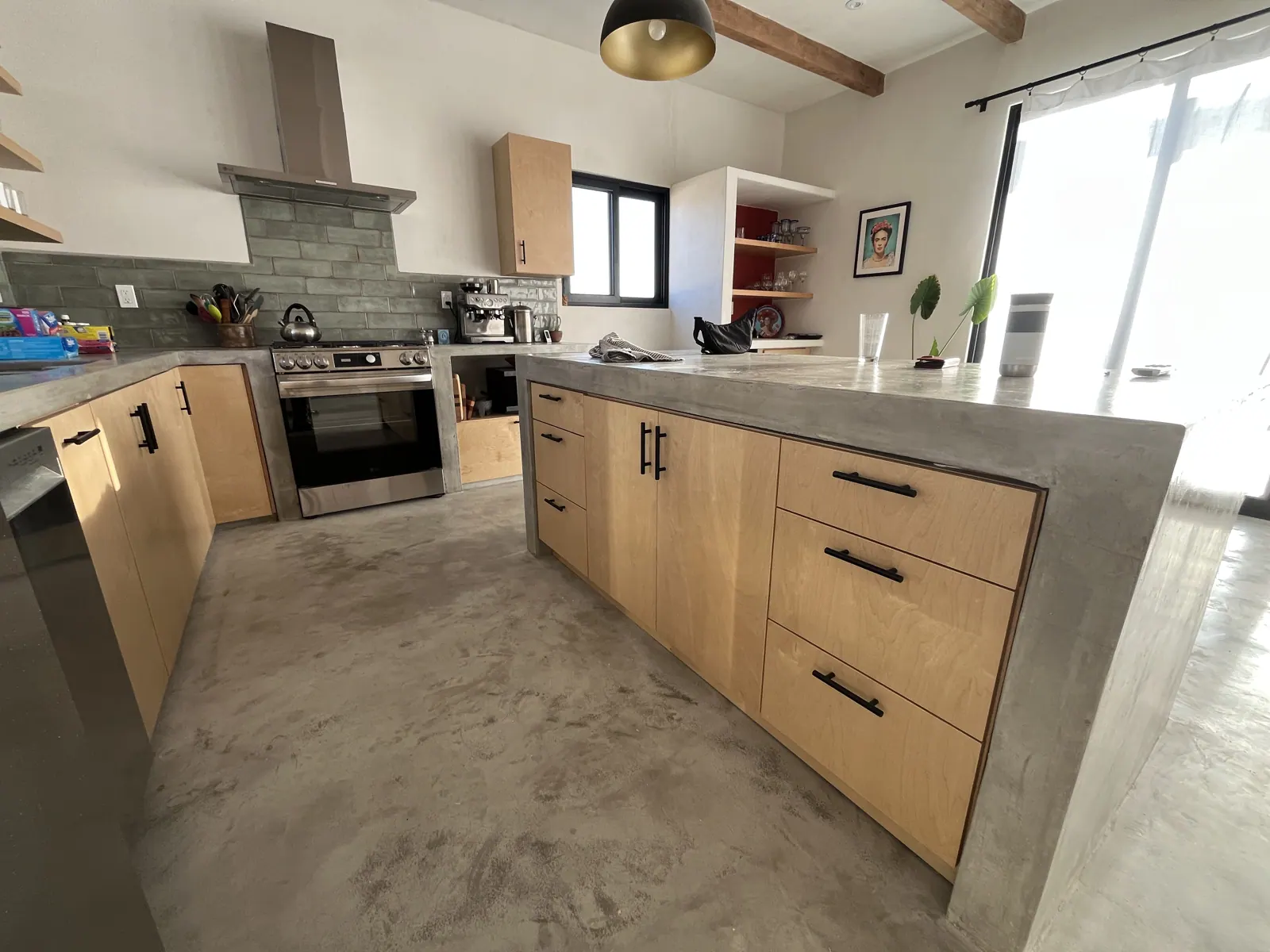Full kitchen with wood island and range wall