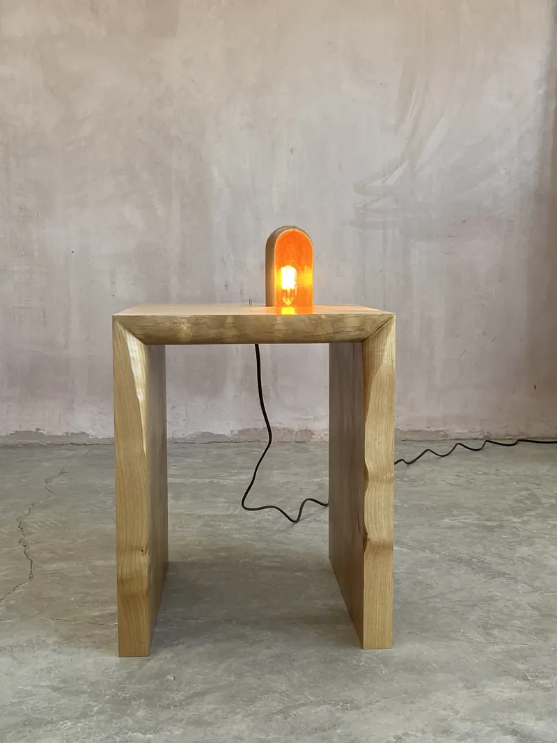 Waterfall side table with a small lamp