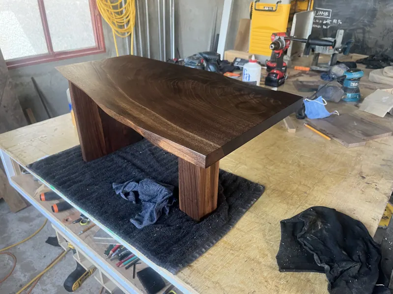 Dark wood table with slab legs on the workbench
